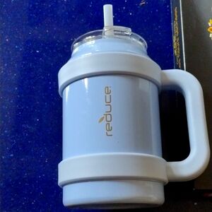 A baby blue thermal water jug with plastic straw.